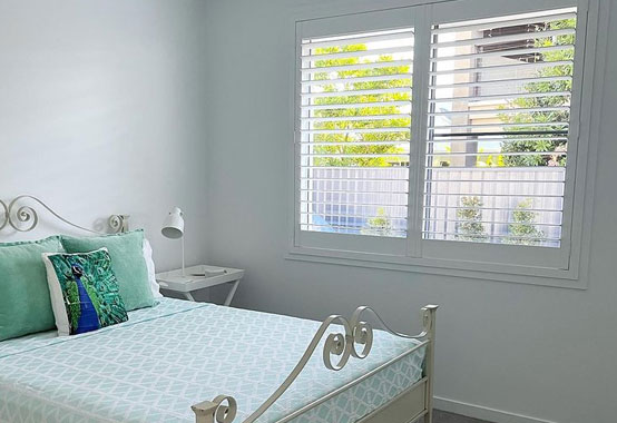 Odyssey Poly Shutters Range In The Bedroom — Premium Window Coverings In Chevallum, QLD