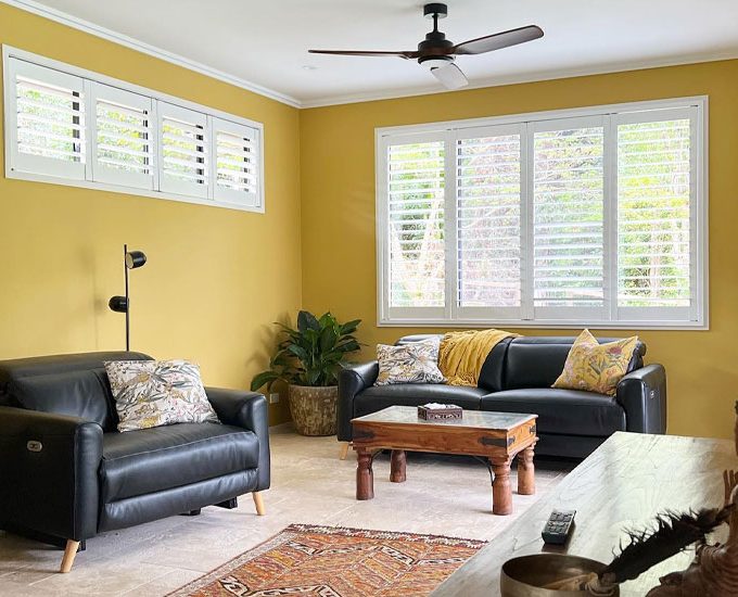 Yellow-walled Living Room Complemented By Australian Made Shutters — Premium Window Coverings In Chevallum, QLD