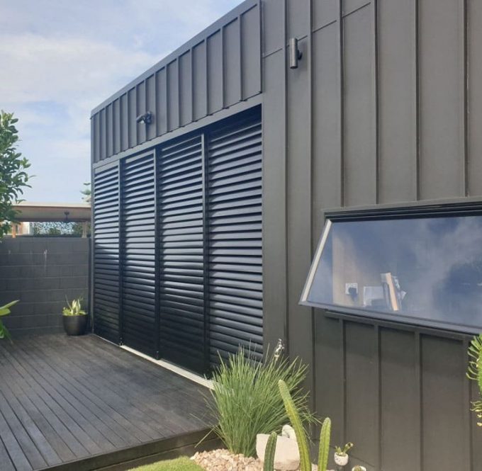 Elegant Black Sliding Shutter — Premium Window Coverings In Chevallum, QLD